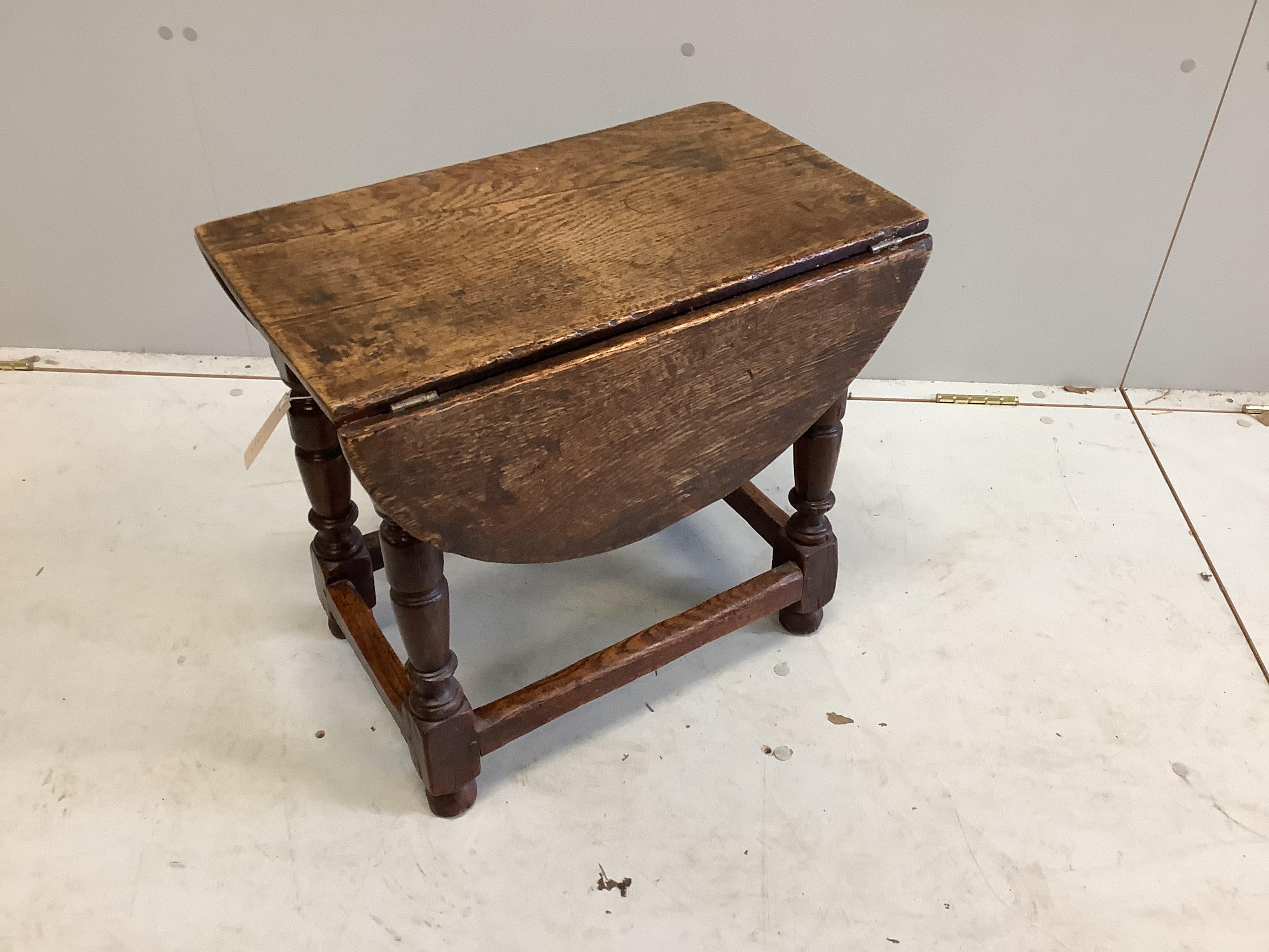 A 17th century style oak drop flap occasional table, width 52cm, depth 32cm, height 48cm